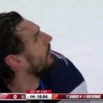 Dylan Larkin shoots the helmet off of Connor Hellebuyck