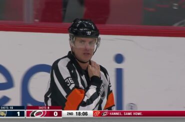 Brett Pesce hits the Puck at the Referee While trying to throw the puck into the offensive zone