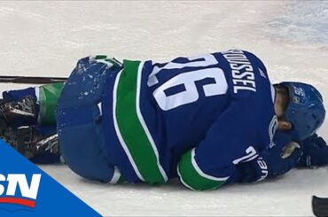 Antoine Roussel Helped Off Ice After Taking Brendan Lemieux Elbow To Head & Landing On Leg