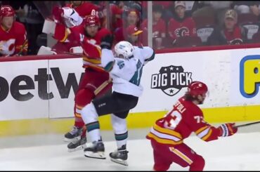 Chris Tanev throws a hit on Tomas Hertl