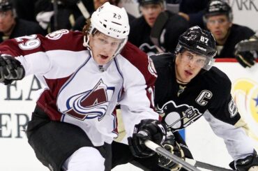 Pittsburgh Penguins' Sidney Crosby dekes out Colorado Avalanche's Nathan MacKinnon
