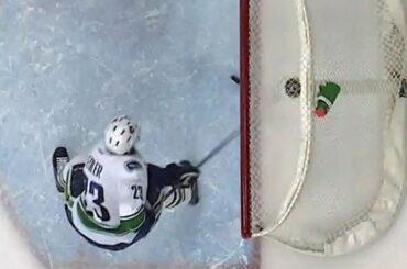 Edler sweeps a rolling puck off the goal line