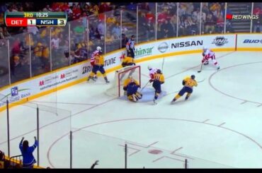 Darren Helm tries to put the net back on after Pekka Rinne knocks it off