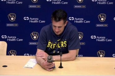 Craig Counsell admires his bobblehead following win over Pirates