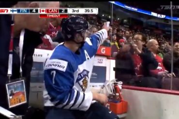 Urho Vaakanainen  signs an autograph for a fan while serving a penalty.
