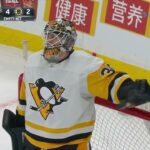 Brad Marchand punches goalie Tristan Jarry in the head.