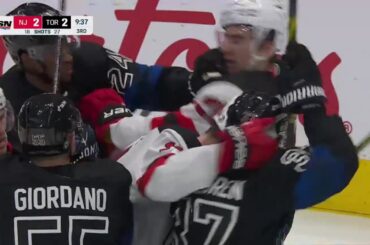 Scrum ensues between the Maple Leafs and the Devils after exchanges of hitting