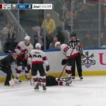 Erik Brannstrom Is Down On The Ice After Taking A Hit From Cal Clutterbuck