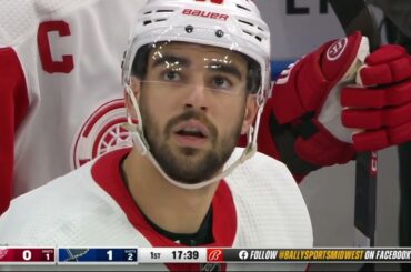 Robert Bortuzzo stick handles in a phone booth