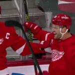 Alex DeBrincat scores a goal against the New Jersey Devils