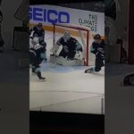 Curtis Lazar's shot gets deflected off of Conor Garland's stick