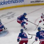 Jack Hughes scores a goal against the New York Rangers