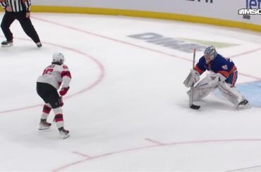 Jack Hughes scores a goal against the New York Islanders