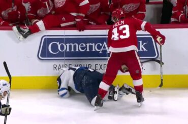 Jets' Byfuglien and Red Wings' Helm exchange big hits moments apart