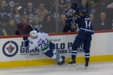 Alex Edler Bounces Off Peluso After Attempted Hit