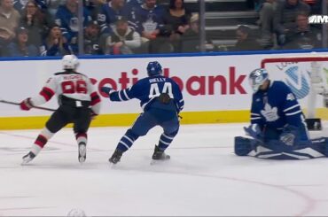Jack Hughes scores a goal against the Toronto Maple Leafs