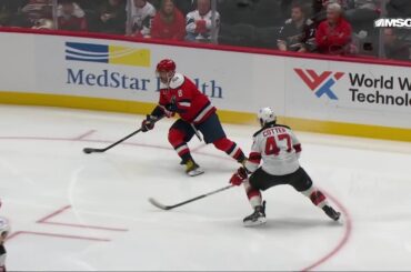 Connor McMichael scores a goal against the New Jersey Devils