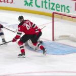 Charlie Coyle scores a goal against the New Jersey Devils