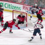 Sean Monahan scores a goal against the New Jersey Devils