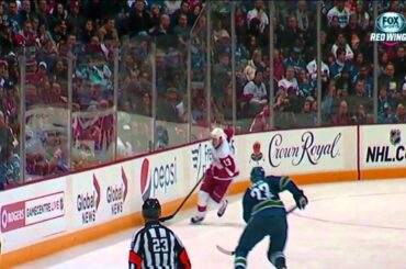 Pavel Datsyuk evades the big hits from Alex Edler and Tuomo Ruutu