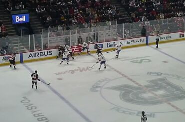 Laval Rocket's Xavier Simoneau gets a high stick in the face from Belleville Senators' Jamieson Rees