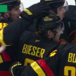 Brock Boeser scores a goal against the New Jersey Devils