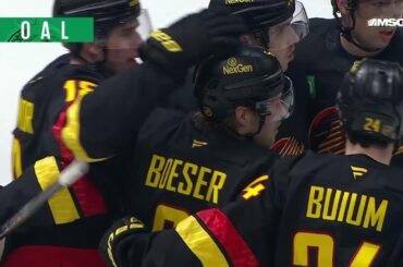 Brock Boeser scores a goal against the New Jersey Devils