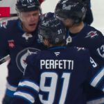 Jonathan Toews scores a goal against the New Jersey Devils