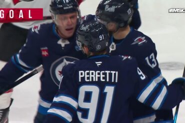 Jonathan Toews scores a goal against the New Jersey Devils