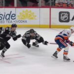 Bo Horvat scores a goal against the New Jersey Devils