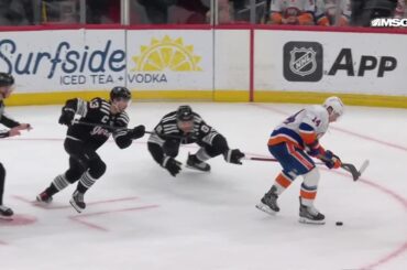 Bo Horvat scores a goal against the New Jersey Devils