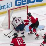 Sean Monahan scores a goal against the New Jersey Devils