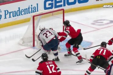 Sean Monahan scores a goal against the New Jersey Devils