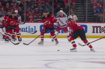 Jack Hughes scores a goal against the New York Rangers