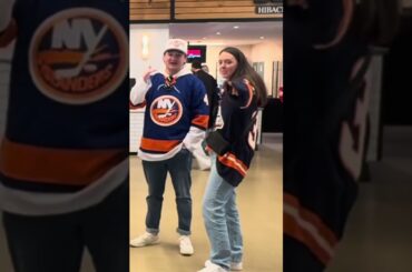 New York Islanders Admin Gives Out Pucks to Fans