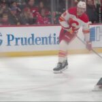 John Beecher scores a goal against the New Jersey Devils