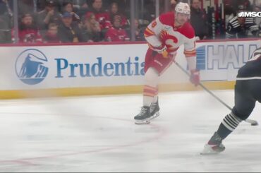 John Beecher scores a goal against the New Jersey Devils