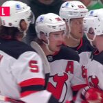 Jack Hughes scores a goal against the Dallas Stars