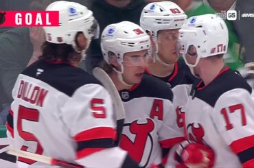 Jack Hughes scores a goal against the Dallas Stars