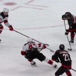 Shayne Gostisbehere scores a goal against the New Jersey Devils