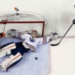Talbot makes snow angel save on his back