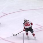 Jack Hughes scores a goal against the Detroit Red Wings